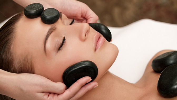 Woman getting a hot stone massage-Life massage and wellness. (cold stone therapy)