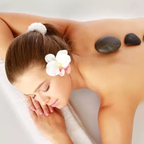 Woman getting a hot stone massage-image alt text within 30 characters (cold stone therapy)