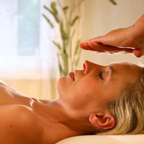 Person receiving Reiki healing-Life massage and wellness (Cranio-Integrative Massage)